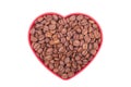 Coffee beans in a dish in the shape of a heart. Royalty Free Stock Photo