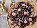 Coffee beans and dried rose buds aromatherapy sachets and mortar.