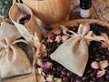 Coffee beans and dried rose buds aromatherapy sachets and mortar.