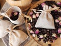 Coffee beans and dried rose buds aromatherapy sachets and mortar.