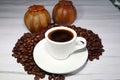 Coffee beans and espressocup on a wooden board