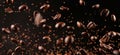 Coffee beans falling on brown background, closeup view Royalty Free Stock Photo