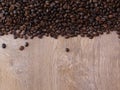 Coffee beans on fine oak tree wood texture pattern background. Space for text.