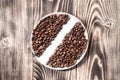 Coffee beans fresh roasted in round bowl on a wooden table