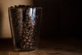 Coffee beans in glass cup on black background Royalty Free Stock Photo