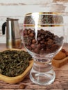 Coffee beans in a glass goblet and green tea Royalty Free Stock Photo