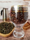 Coffee beans in a glass goblet and green tea Royalty Free Stock Photo