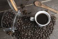 Coffee beans in glass jar with american black coffee cup on old wooden table.Creative cafe concept on rustic background Royalty Free Stock Photo