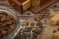 Coffee beans in a glass jar, coffee grinder, pieces of brown sugar on a wooden background. Close up Royalty Free Stock Photo