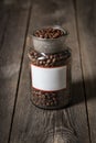 Coffee beans in a glass jar placed on wooden table Royalty Free Stock Photo