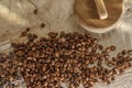 Coffee beans in glass jar with wood lid on solid wood creamy stump. Royalty Free Stock Photo