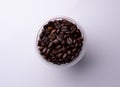 brown coffee beans in a small glass on a light background Royalty Free Stock Photo