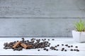 Coffee beans, green flower pot, cinnamon on a wooden table. Breakfast coffee. Morning. espresso