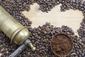 Coffee beans, grinder and on a wooden table with grounded coffe Royalty Free Stock Photo