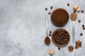 Coffee beans, ground coffee, brown sugar cane, star anise and cinnamon in wooden bowls on a gray background Royalty Free Stock Photo