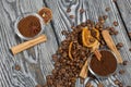 Coffee beans. Ground coffee in containers and spices. On a surface of brushed pine boards painted black and white Royalty Free Stock Photo