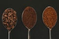 Coffee beans, ground and instant coffee granules in spoons, top view Royalty Free Stock Photo