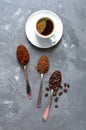 Coffee beans, ground and instant coffee in the spoons and a cup of fresh espresso. Royalty Free Stock Photo