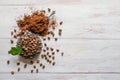 Coffee beans and ground powder on white wooden background. Top view with copy space Royalty Free Stock Photo