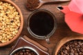 Coffee beans with ground coffee in wooden spoon and red kettle on the side Royalty Free Stock Photo