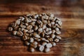 Coffee beans in the hands of heart shaped on wood table dark style