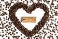 Coffee beans in heart shape and cinnamon in the center Royalty Free Stock Photo