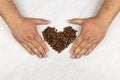 Coffee beans in heart shape on the grey marble table with copy space Royalty Free Stock Photo