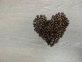 Coffee beans in heart shape on wooden background, Heart symbol with valentine`s day Royalty Free Stock Photo