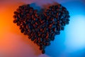 Coffee beans are highlighted with neon lined in the shape of a heart