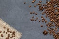 Coffee beans and ingredients on black stone background, top view