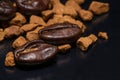 Coffee beans and instant coffee granules on a dark background Royalty Free Stock Photo