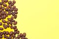 Coffee beans isolated on the yellow background. Joyful coffee-theme Royalty Free Stock Photo