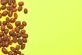 Coffee beans isolated on the yellow background. Joyful coffee-theme Royalty Free Stock Photo