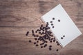 Coffee beans and and lined paper on wooden table top view Royalty Free Stock Photo