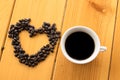 Coffee beans Love cup on wood table Royalty Free Stock Photo