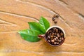 Coffee beans in a mug with leaves