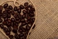 Coffee beans on a napkin of natural burlap background. Royalty Free Stock Photo