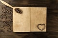 Coffee beans on old vintage open book. Menu, recipe, mock up. Wooden background. Royalty Free Stock Photo