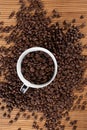 Coffee beans overflowing from a beautiful cup Royalty Free Stock Photo