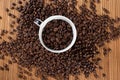 Coffee beans overflowing from a beautiful cup Royalty Free Stock Photo