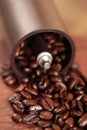 Coffee beans overflowing from the coffee mill Royalty Free Stock Photo