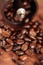 Coffee beans overflowing from the coffee mill Royalty Free Stock Photo