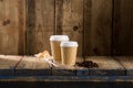 Coffee Beans, Pastry Balls, and Ribbed Paper Cups on Wooden Shelf