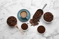 Coffee beans, powder and cup of drink on white marble table, flat lay Royalty Free Stock Photo