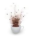 Coffee beans and powder spilled out from cup