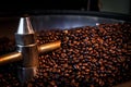 Coffee beans process roasted spin machine close up and selective focus Royalty Free Stock Photo