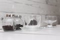 Coffee beans and processed tea leaves in glass jars, and clean glassware Royalty Free Stock Photo