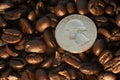 Coffee beans and quarter coin