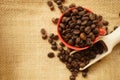 Coffee beans and the red cup on gunny bag Royalty Free Stock Photo