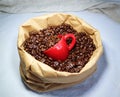 Coffee beans and a red cup in a paper bag Royalty Free Stock Photo